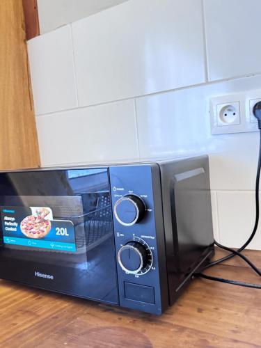 a microwave oven with a pizza inside of it at Akhard Haus in Buea