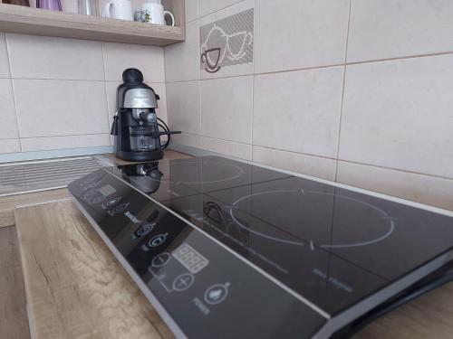 a stove top with a coffee pot on top of it at Potyka Apartman in Tiszafüred