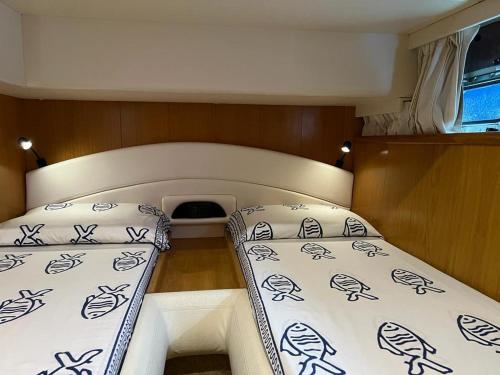 a small room with two beds in a boat at Mythos presso Ristorante Il Gambero Rosso in Porto Ercole