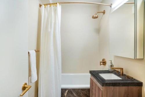 a bathroom with a shower with a sink and a tub at 52-3DE Newly renovated 2BR BTH Midtown East in New York