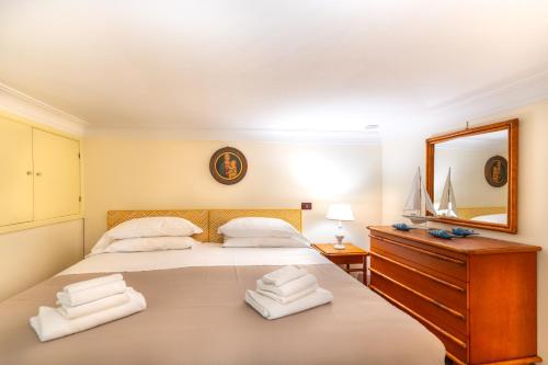 a bedroom with a large bed and a mirror at Flat Rosanna in Sorrento