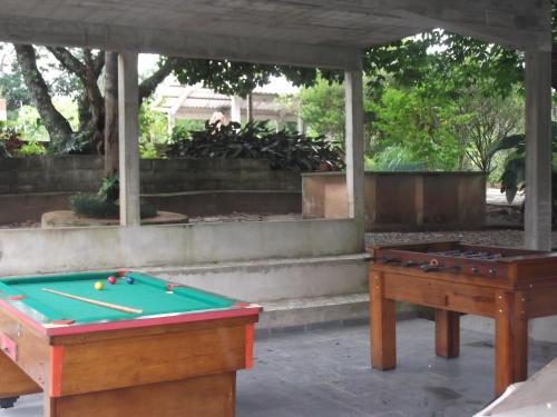 two pool tables sitting under a gazebo at Sítio Colina das Flores. Lugar Encantador com Piscina para Grupos in Franco da Rocha
