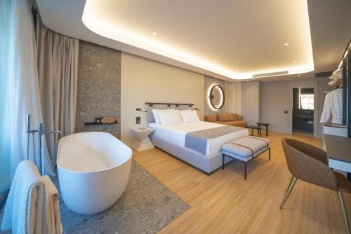 a hotel room with a bed and a bath tub at ALYACHT Premium Hotel in Sarandë