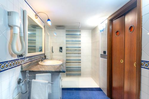 a bathroom with a sink and a mirror at Flat Rosanna in Sorrento