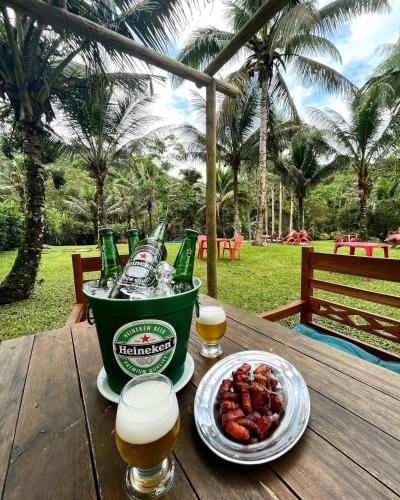 a bucket of beer and a plate of food on a table at Recanto Cachoeira in Paraty