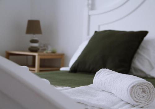 a white towel sitting on top of a bed at Il Fungo di Lacco in Ischia