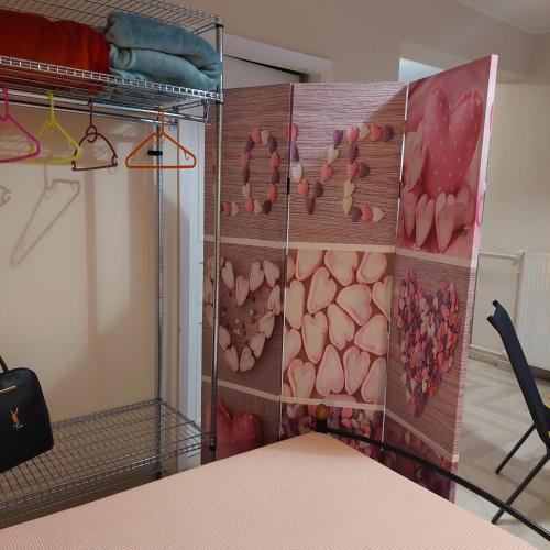 a room with a closet with flowers on the wall at Family Apartment in Patra