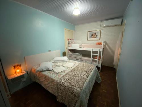 Dormitorio pequeño con cama y cuna en Gramado Centro Residence, en Gramado