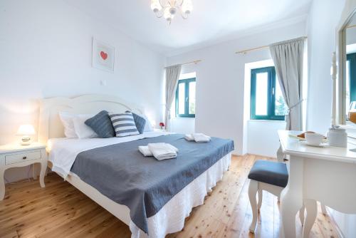 a white bedroom with a bed and a desk at Villa Tereza with Private Pool Sea View in Mlini