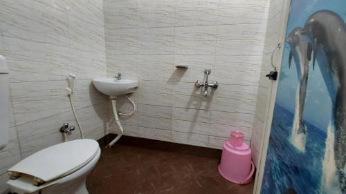 a bathroom with a toilet and a sink at GRG M S M Residency Puri in Puri