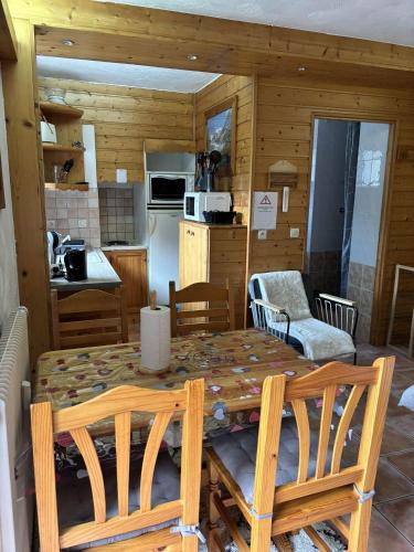 eine Küche und ein Esszimmer mit einem Tisch und Stühlen in der Unterkunft Grand bec in Brides-les-Bains