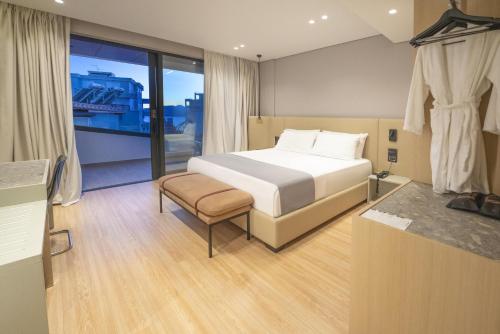 a hotel room with a bed and a window at ALYACHT Premium Hotel in Sarandë