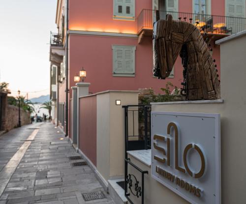 a sign on the side of a building on a street at Silo Luxury Rooms in Nafplio