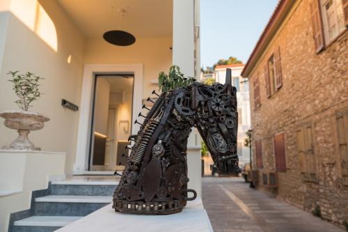 a statue of a horse standing on a street at Silo Luxury Rooms in Nafplio