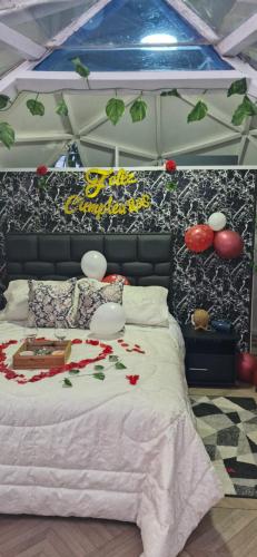 a bedroom with a bed with flowers on it at Hotel El Ganadero in El Total