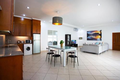 a kitchen and living room with a table and chairs at Magic Villas Pattaya in Pattaya South