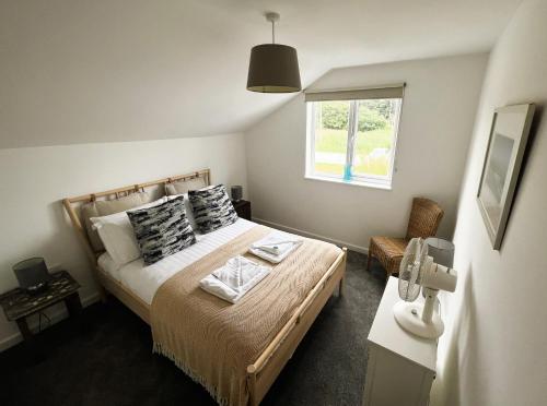 a bedroom with a bed and a window at Temperance in Freshwater