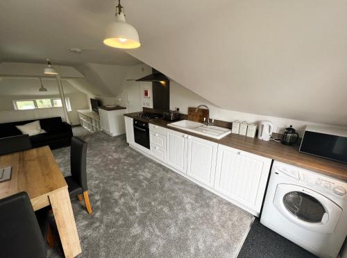 a kitchen with a washer and dryer in a room at Temperance in Freshwater