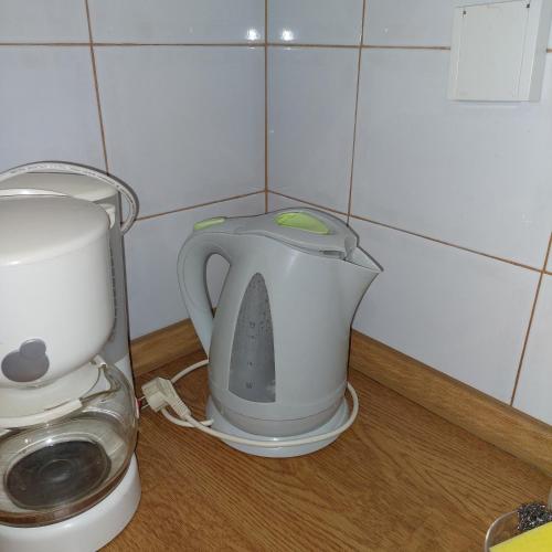 a tea kettle and a blender sitting on a counter at Family Apartment in Patra