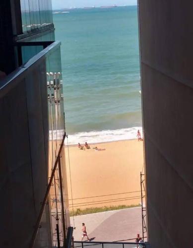 a view of a beach from a building at Prédio Frente Mar Praia da Costa 08 in Vila Velha