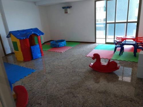 a room with a play area with a toy horse at Prédio Frente Mar Praia da Costa 08 in Vila Velha