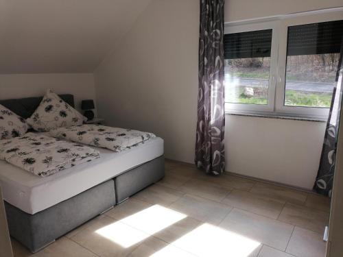 a small bedroom with a bed and a window at Haus Kleeblatt in Cochem