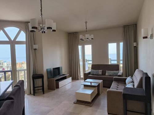 a living room with a couch and a table at Roof top apartment with panorama view in Hurghada