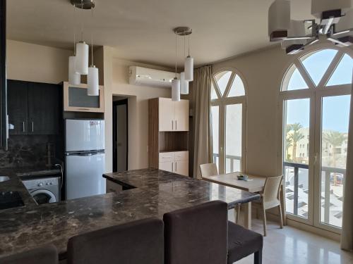 a kitchen and dining room with a table and chairs at Roof top apartment with panorama view in Hurghada