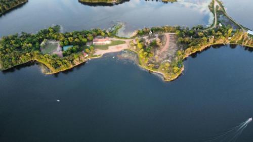 an island in the middle of a body of water at Nature Escape with Studio- Style Rooms Lake View in Clitherall