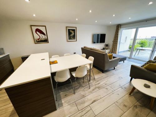 a living room with a table and chairs at The Beach Retreat in Sandown