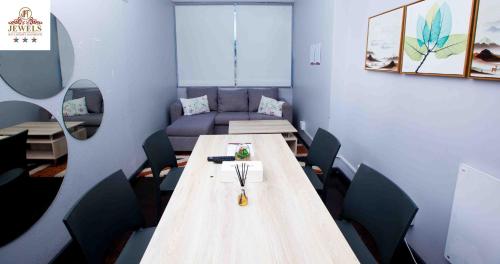a conference room with a long table and chairs at JFT self catering units in East London