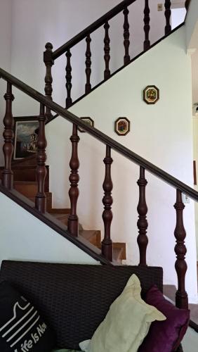a stair case with a couch under a set of stairs at Casa Pé na Areia Cantão do Bora Bora - Manaaki Surf Hostel in São Sebastião