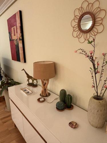 a white dresser with a lamp and plants on it at Ático El Reducto views in Arrecife