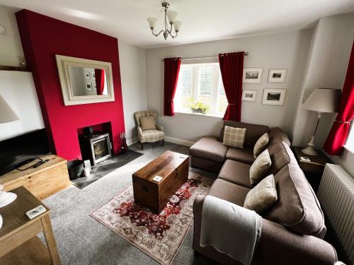 a living room with a couch and a table at The Old Abbey Farmhouse - Pet Friendly in Ryde