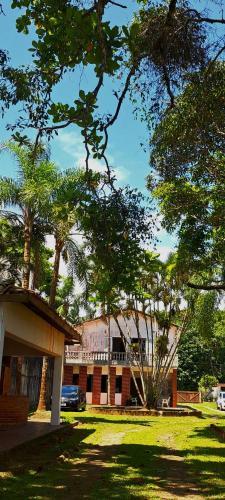 a building with a lot of trees in front of it at Casa Pé na Areia Cantão do Bora Bora - Manaaki Surf Hostel in São Sebastião