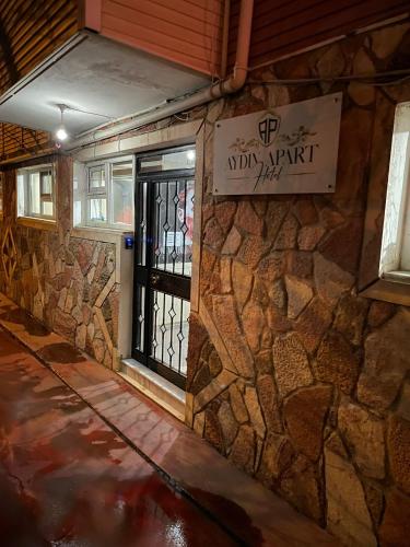 a door to a building with a sign on it at AYDIN APART HOTEL in Balıkesir