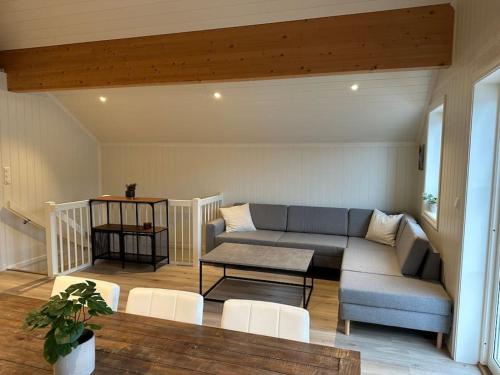 a living room with a couch and a table at Rorbu i Gilsvågen - Egen Brygge - Båtutleie in Blænes