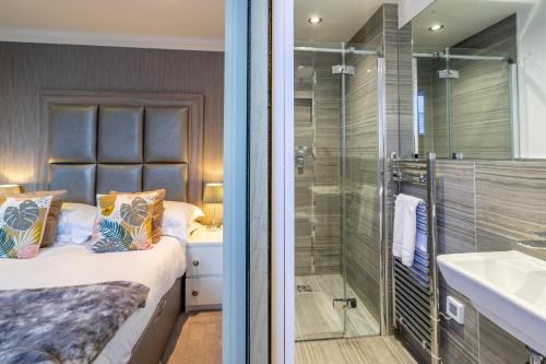 a bathroom with a bed and a shower and a sink at 31 Cocoa Suites in York