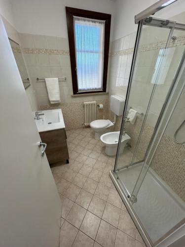 a bathroom with a toilet and a sink and a shower at Forli Sud - Romagna Central Suite Apartment - Parking in Forlì