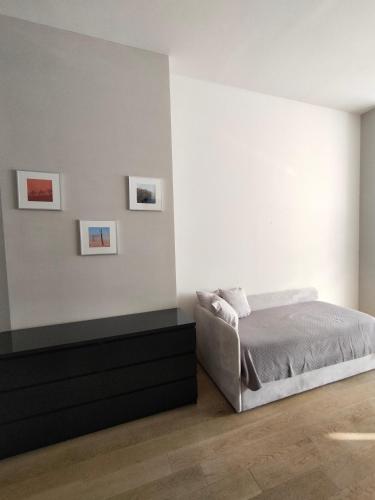 a bedroom with a bed and a black dresser at Appartamento Loft in Turin