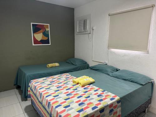 two beds sitting next to each other in a room at Casa da Esquina Pousada in Recife
