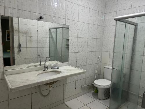 a bathroom with a sink and a toilet at Casa da Esquina Pousada in Recife