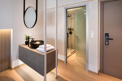 a bathroom with a sink and a mirror at Pelagus City - Luxury Suite I in Thessaloniki