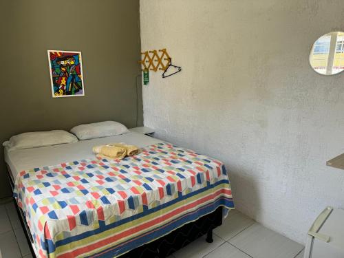 a bedroom with a bed with a purse on it at Casa da Esquina Pousada in Recife