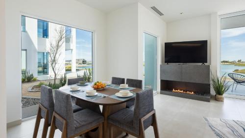 a dining room with a table and a fireplace at Costa Divina LV 12 Brand New by Kivoya in Puerto Peñasco