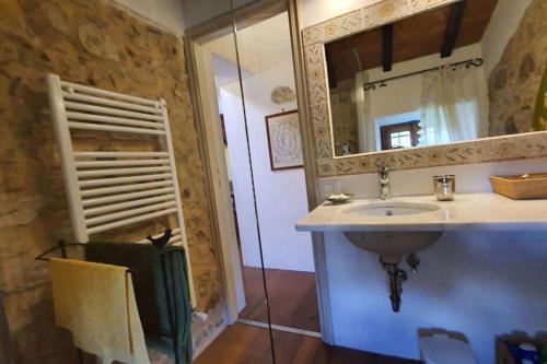 a bathroom with a sink and a mirror at Il Cantuccio Proprietà in Pescaglia