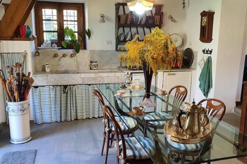 a dining room with a glass table and chairs at Il Cantuccio Proprietà in Pescaglia