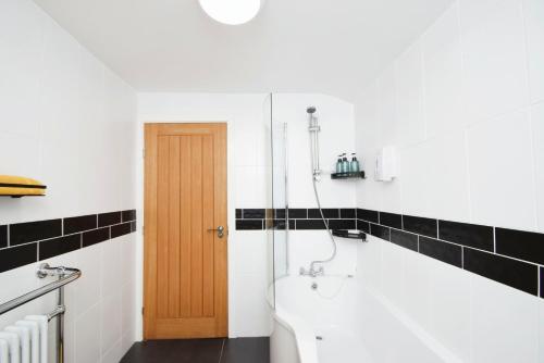 a bathroom with a shower and a toilet in it at Modern Cottage 3 Bed Family Walking & Cycling in Cefn-coed-y-cymmer