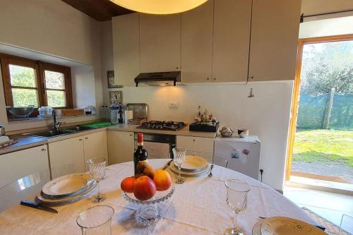 a kitchen with a table with a bowl of fruit on it at Il Cantuccio Proprietà in Pescaglia