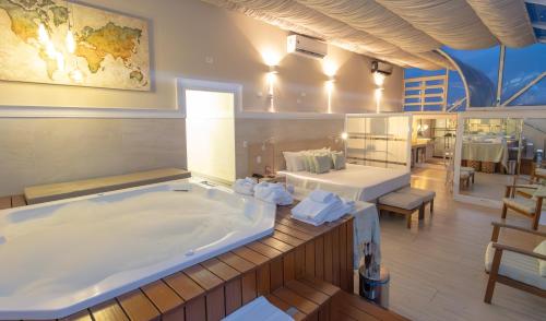 a large bath tub in a room with a table at Lizon Curitiba Hotel in Curitiba